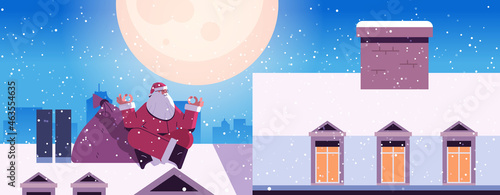 santa claus sitting lotus pose on the roof of house building merry christmas happy new year winter holidays celebration
