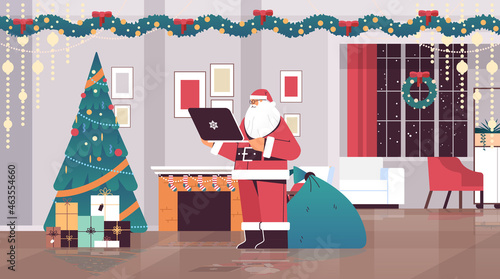 santa claus using laptop social media network merry christmas happy new year winter holidays celebration
