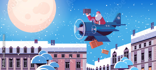 santa claus flying airplane with gifts merry christmas happy new year winter holidays celebration concept