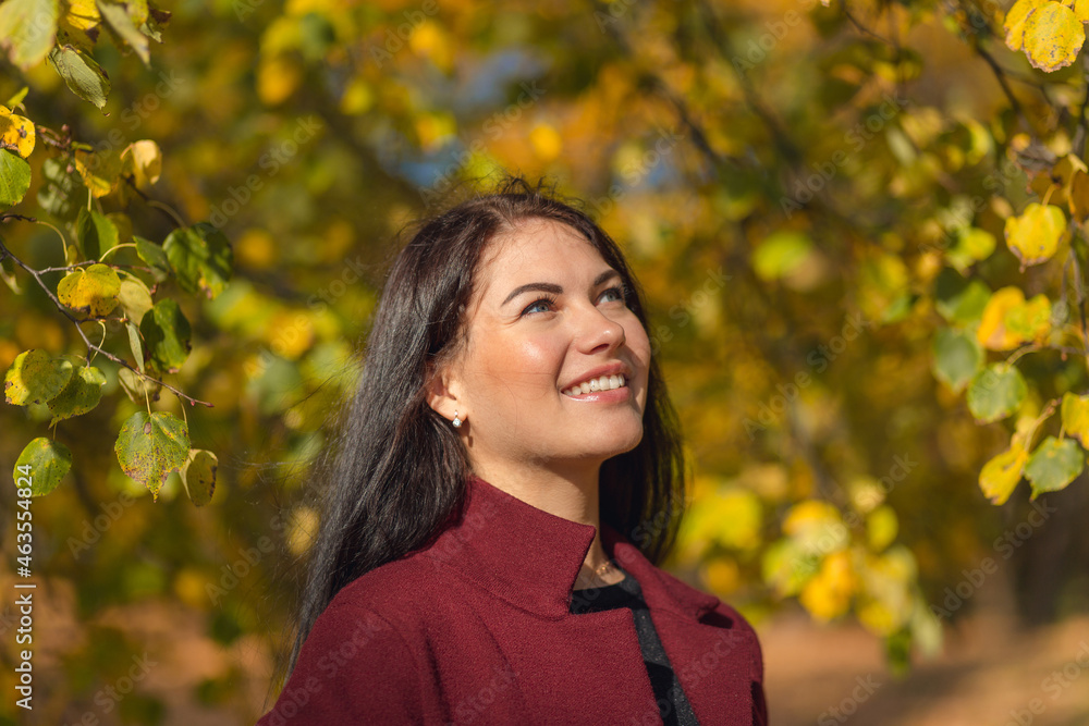 Portrait of a joyful young woman enjoying in the autumn park. Portrait of a joyful young woman enjoying in the autumn park.