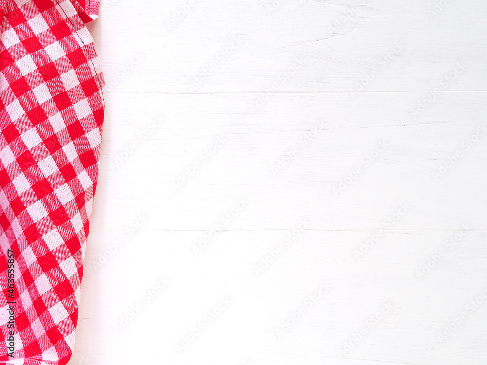 Top view, close-up of red and white checkered fabric or napkin on white table background. Concept kitchen utensils and tableware. Top view, flat lay with copy space.. Top view, close-up of red and white checkered fabric or napkin on white table background. Concept kitchen utensils and tableware. Top view, flat lay with copy space..