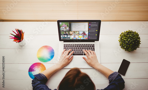 Caucasian woman using laptop for video call, with smiling diverse elementary school pupils on screen