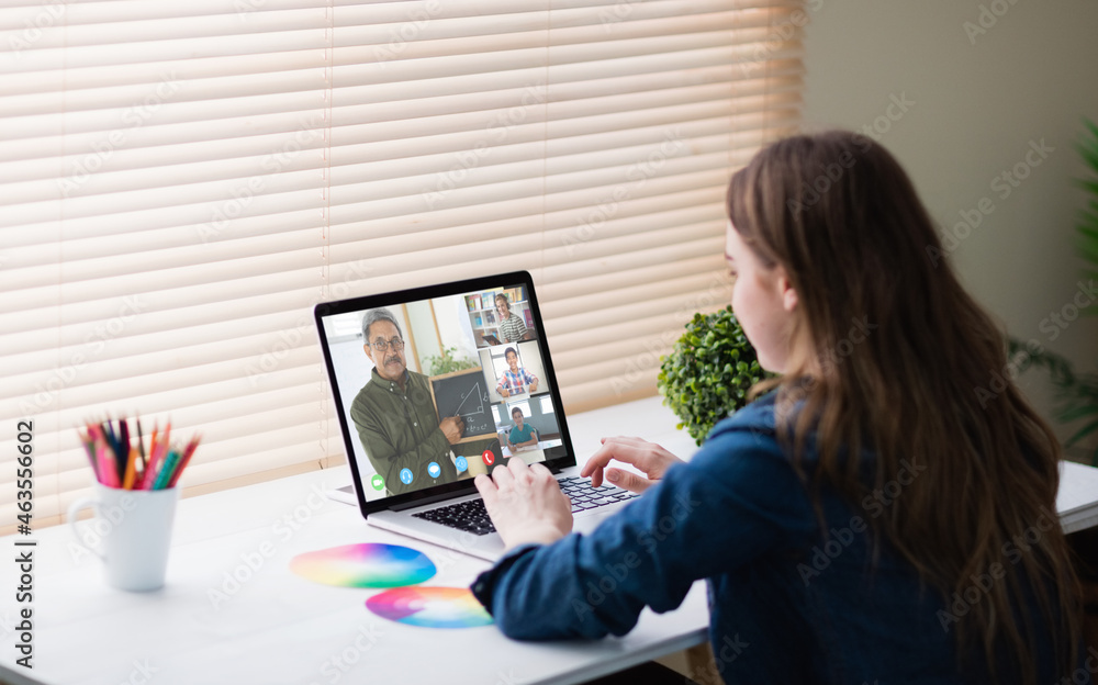 Caucasian girl using laptop for video call, with smiling diverse high school pupils on screen Caucasian girl using laptop for video call, with smiling diverse high school pupils on screen