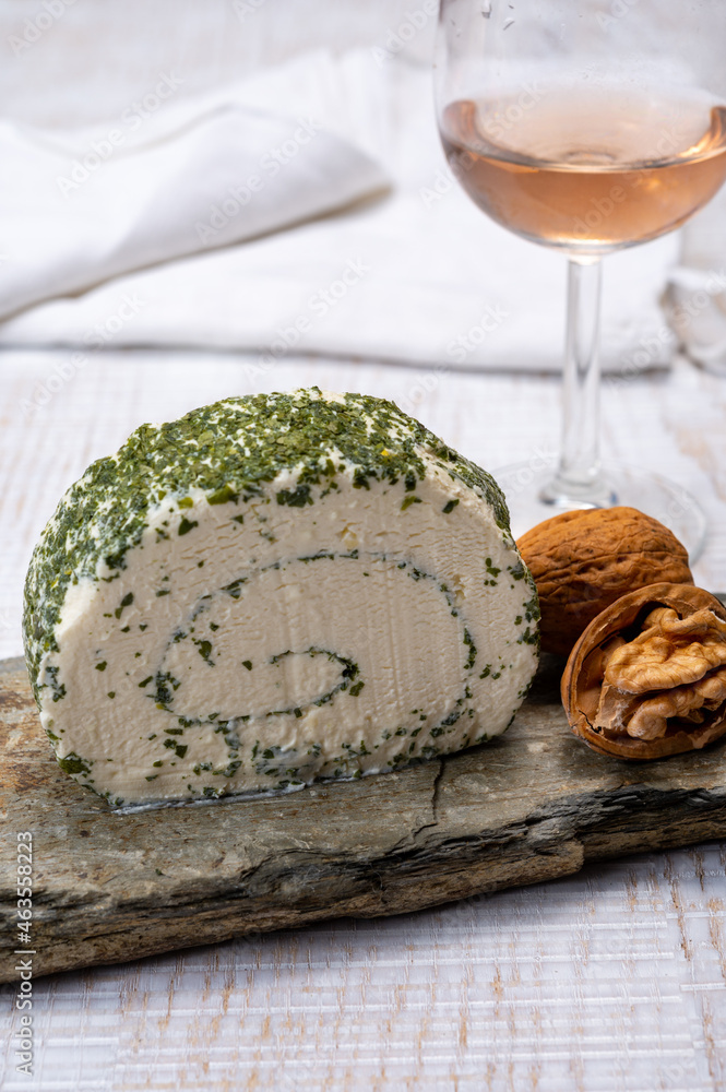 Cheese collection, fresh white soft goat French cheese roll with aromatic herbs and chives Cheese collection, fresh white soft goat French cheese roll with aromatic herbs and chives