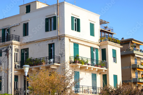 Old town architecture, Corfu. Medieval buildings in Greece island. Photo of local apartment building on streets in Corfu, Kerkyra. Windows with shutters. Facades of old houses. Traveling concept.