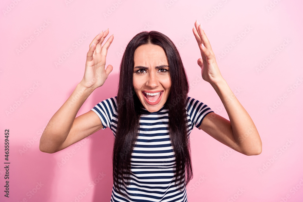 Photo portrait of young girl in striped clothes shouting screaming arguing isolated on pastel pink color background Photo portrait of young girl in striped clothes shouting screaming arguing isolated on pastel pink color background