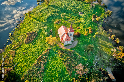 Aerial view of Church of St. Linhart in South Moravia on the island in stunning evening golden hour HDR photo