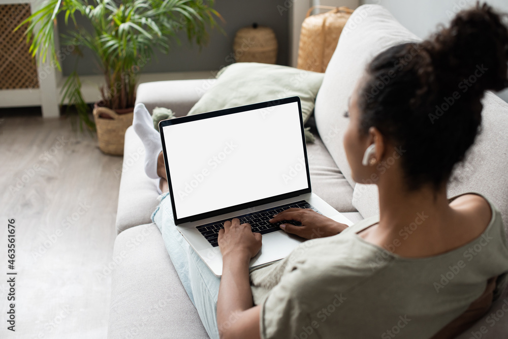 Young woman using laptop computer at home. Blank empty white screen ...