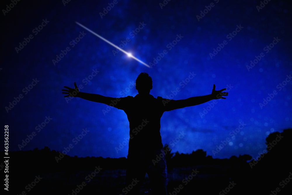 Silhouette of a man enjoying countryside under the starry skies. Silhouette of a man enjoying countryside under the starry skies.