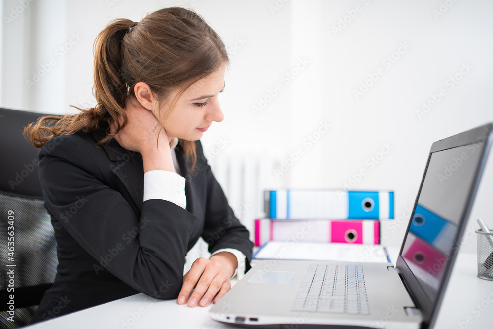 Business woman with neck pain in office Business woman with neck pain in office