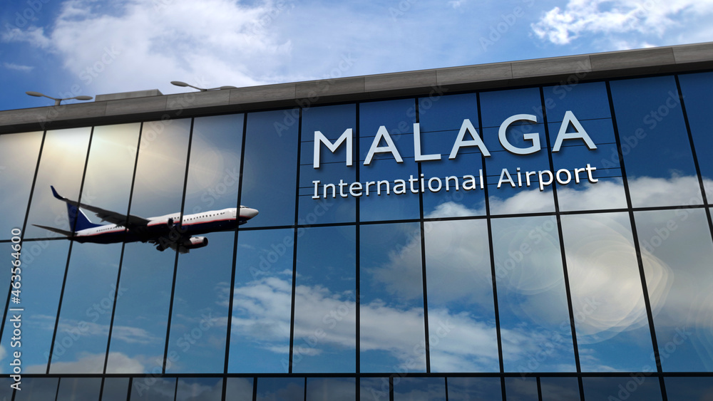 Airplane landing at Malaga Spain airport mirrored in terminal - obrazy, fototapety, plakaty 