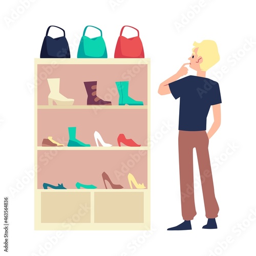 White male standing at shoes shop before shoe rack with woman's shoes, bags and boots.
