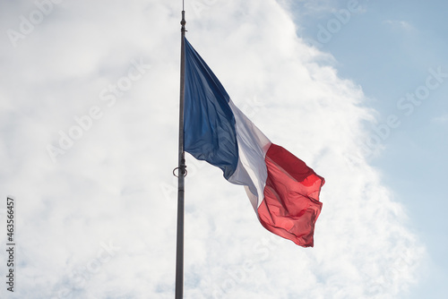 Canvas Print Closeup of french flag floating on blue sky background