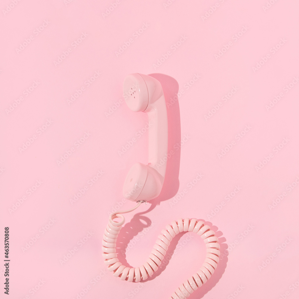 Pastel pink retro telephone handset on pastel pink background. Vintage ...