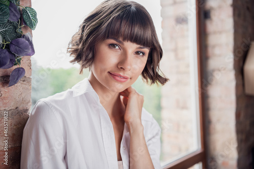 Photo of lovely bob brunette hairdo millennial lady touch neck wear white shirt alone at home