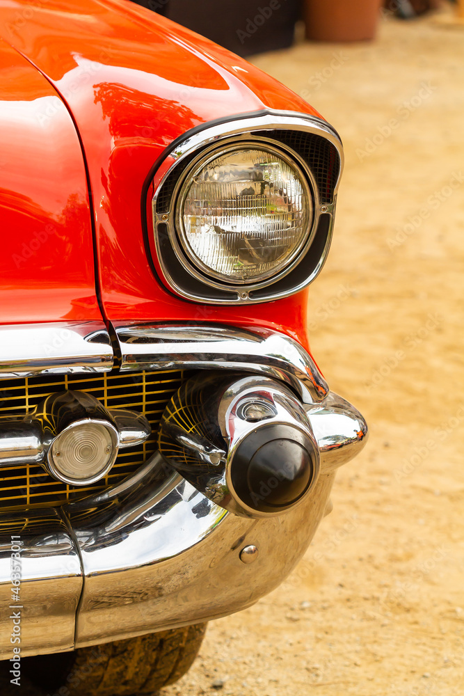 Fototapeta premium Front detail of the fender and headlight of the red chevrolet in havana (Cuba).