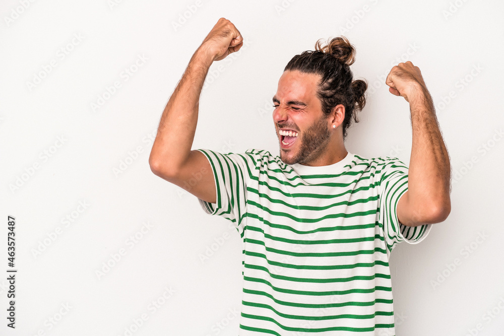 Young caucasian man isolated on white background raising fist after a victory, winner concept. Young caucasian man isolated on white background raising fist after a victory, winner concept.