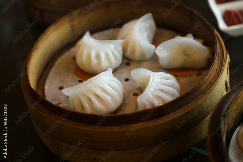 Fototapeta premium Traditional Chinese dumplings, served in a steamer box