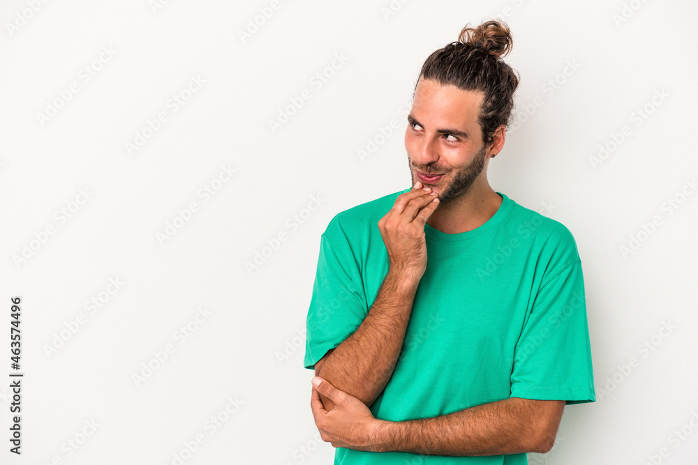 Young caucasian man isolated on white background relaxed thinking about something looking at a copy space. Young caucasian man isolated on white background relaxed thinking about something looking at a copy space.