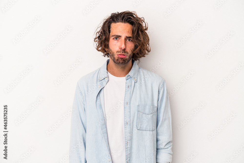 Obraz premium Young caucasian man isolated on white background sad, serious face, feeling miserable and displeased.
