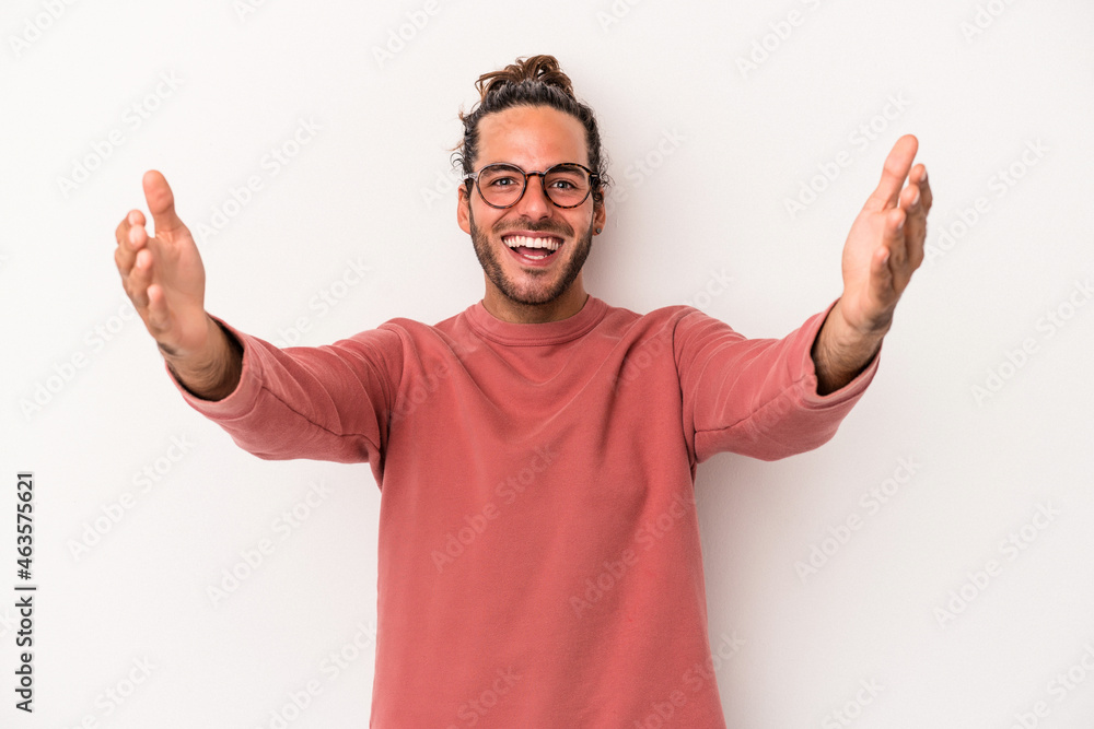 Naklejka premium Young caucasian man isolated on white background celebrating a victory or success, he is surprised and shocked.