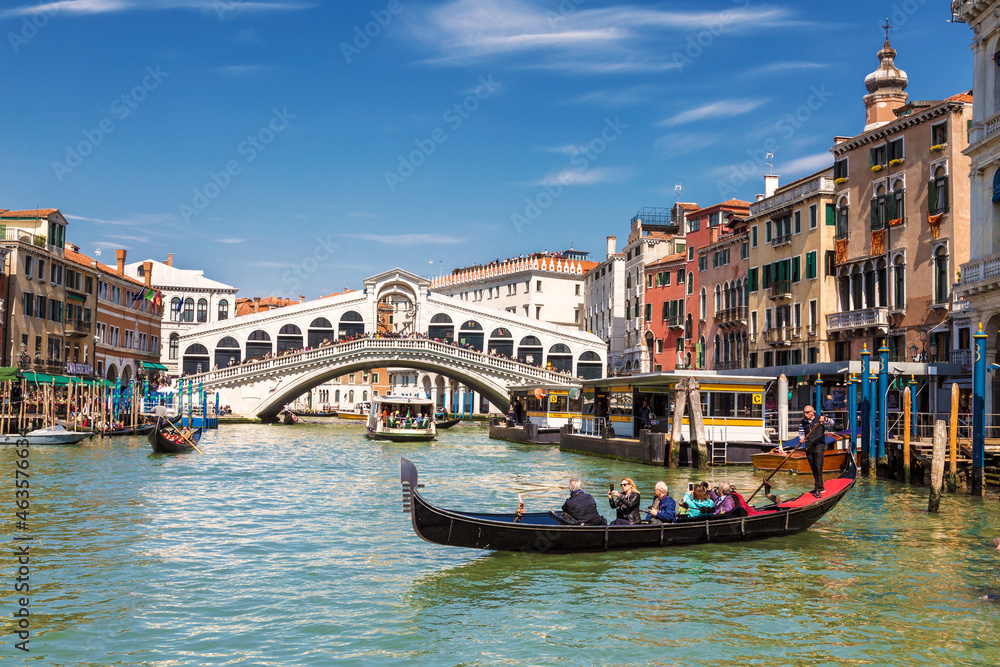 View of the Grand Canal in Venice with the Rialto Bridge and gondolas. Italy