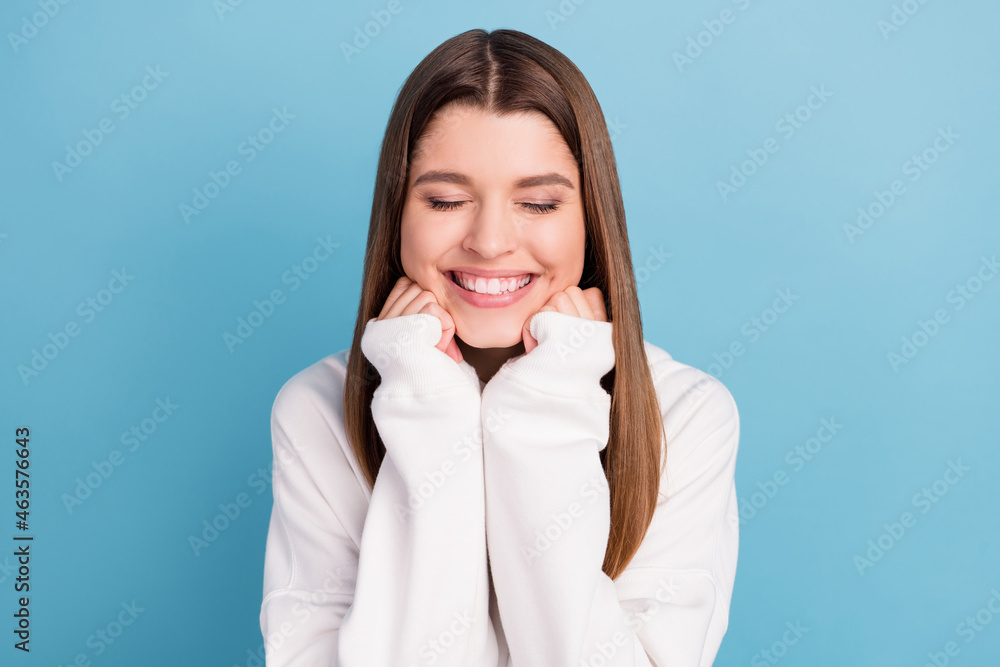 Photo portrait girl wearing white clothes smiling dreamy closed eyes isolated pastel blue color background Photo portrait girl wearing white clothes smiling dreamy closed eyes isolated pastel blue color background