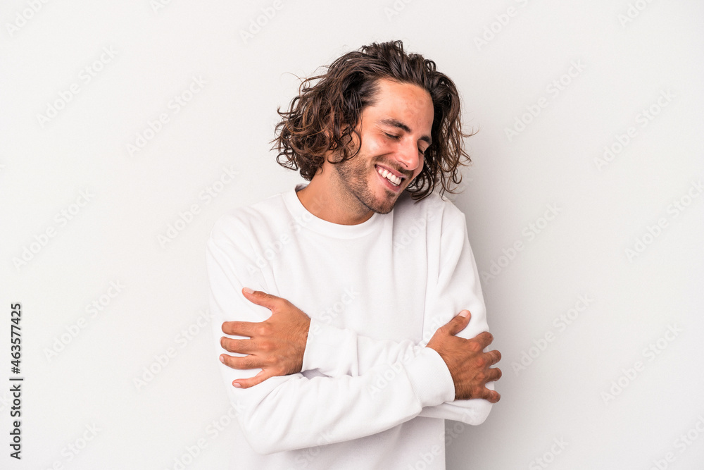 Young caucasian man isolated on gray background laughing and having fun. Young caucasian man isolated on gray background laughing and having fun.