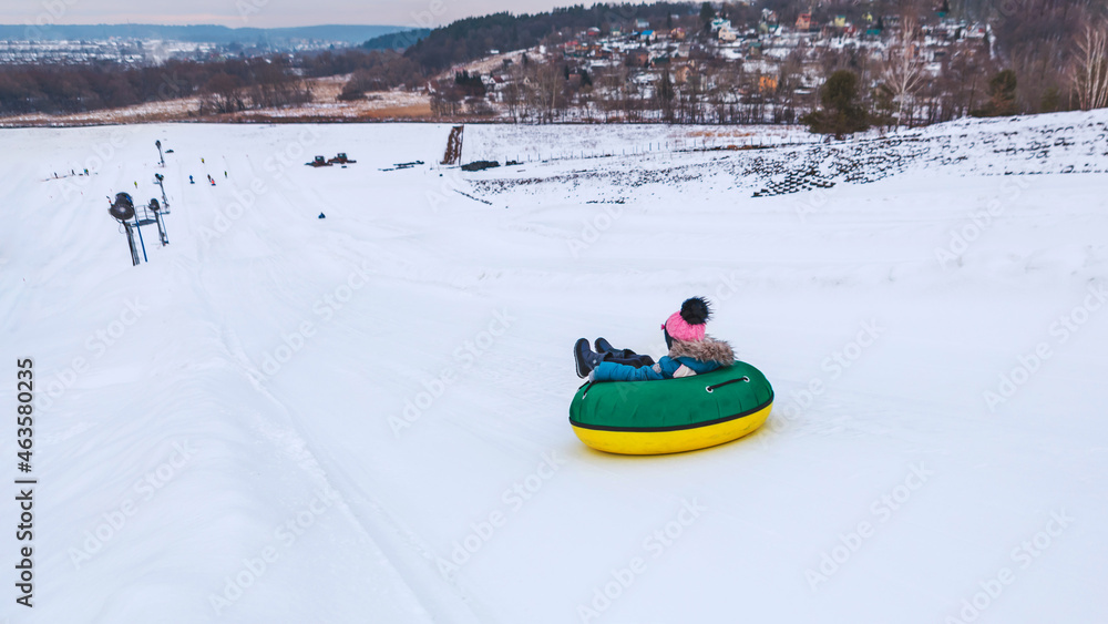 people riding snow tubing at winter park