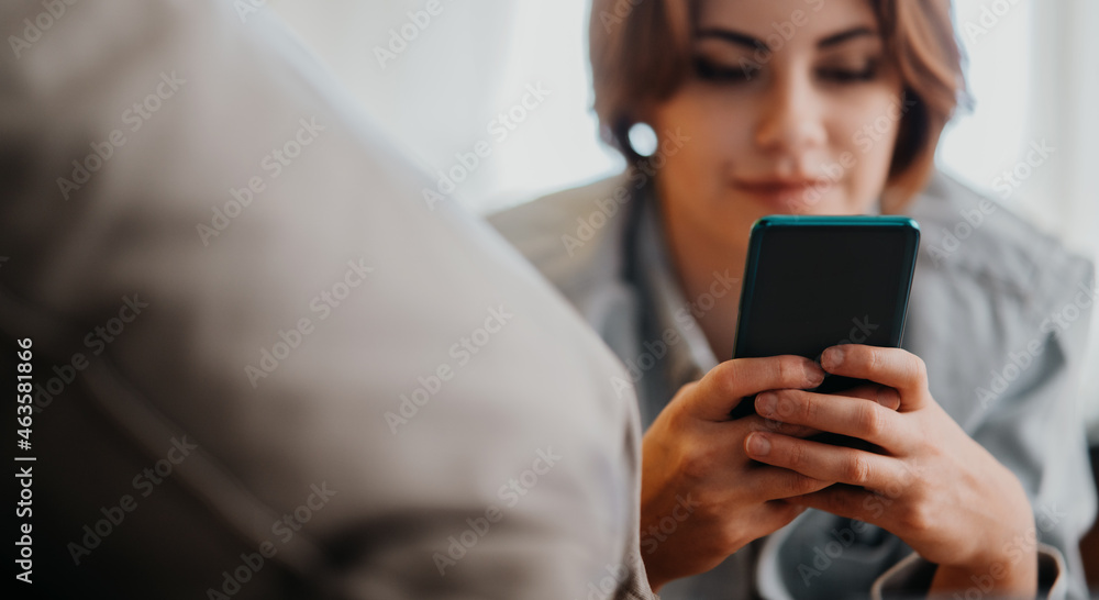 Portrait of young woman using smartphone, lying on sofa at home, social networks concept. Portrait of young woman using smartphone, lying on sofa at home, social networks concept.