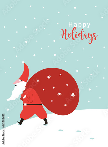 Santa Claus carrying a big  sack of gifts. Santa walking in the snow. Greeting Christmas card