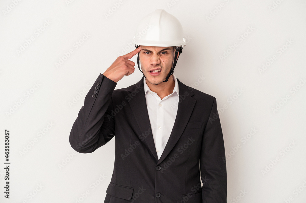 Young architect caucasian man isolated on white background showing a disappointment gesture with forefinger.