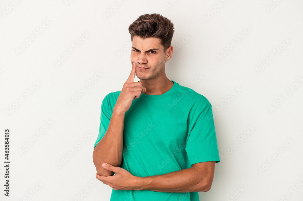 Young caucasian man isolated on white background unhappy looking in camera with sarcastic expression. Young caucasian man isolated on white background unhappy looking in camera with sarcastic expression.