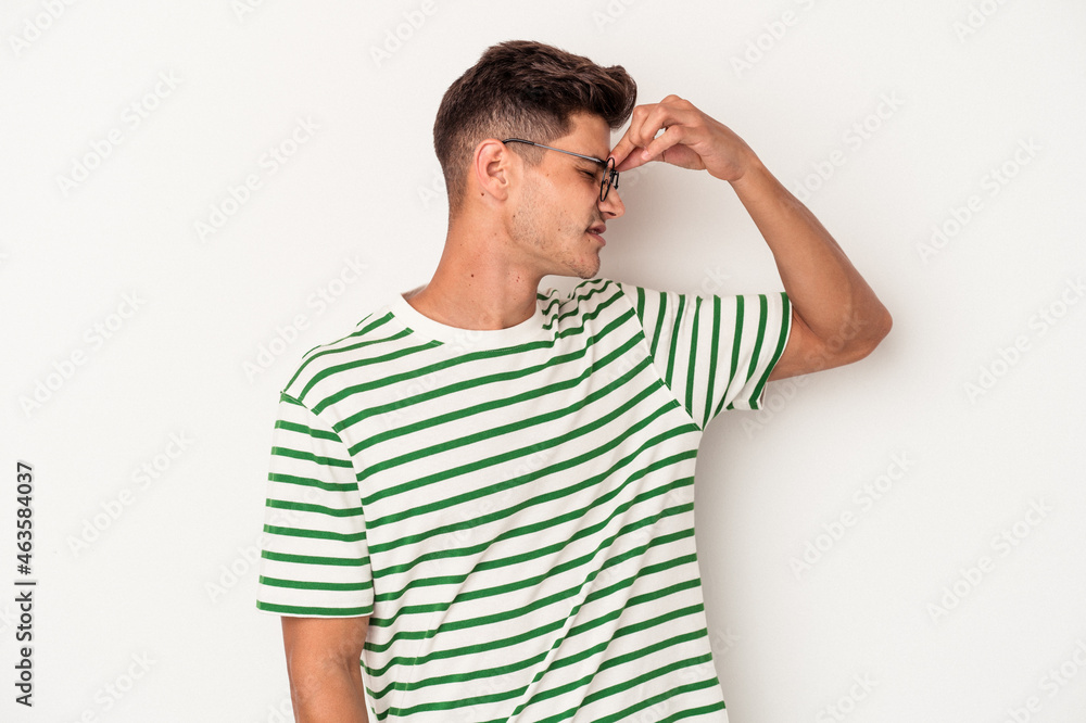 Young caucasian man isolated on white background having a head ache, touching front of the face. Young caucasian man isolated on white background having a head ache, touching front of the face.