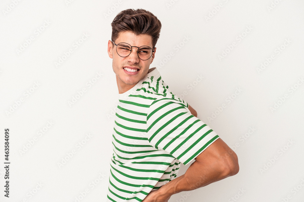 Young caucasian man isolated on white background suffering a back pain. Young caucasian man isolated on white background suffering a back pain.