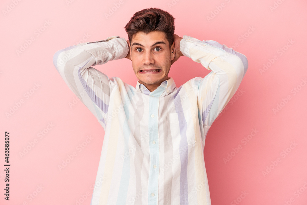 Young caucasian man isolated on pink background screaming with rage. Young caucasian man isolated on pink background screaming with rage.