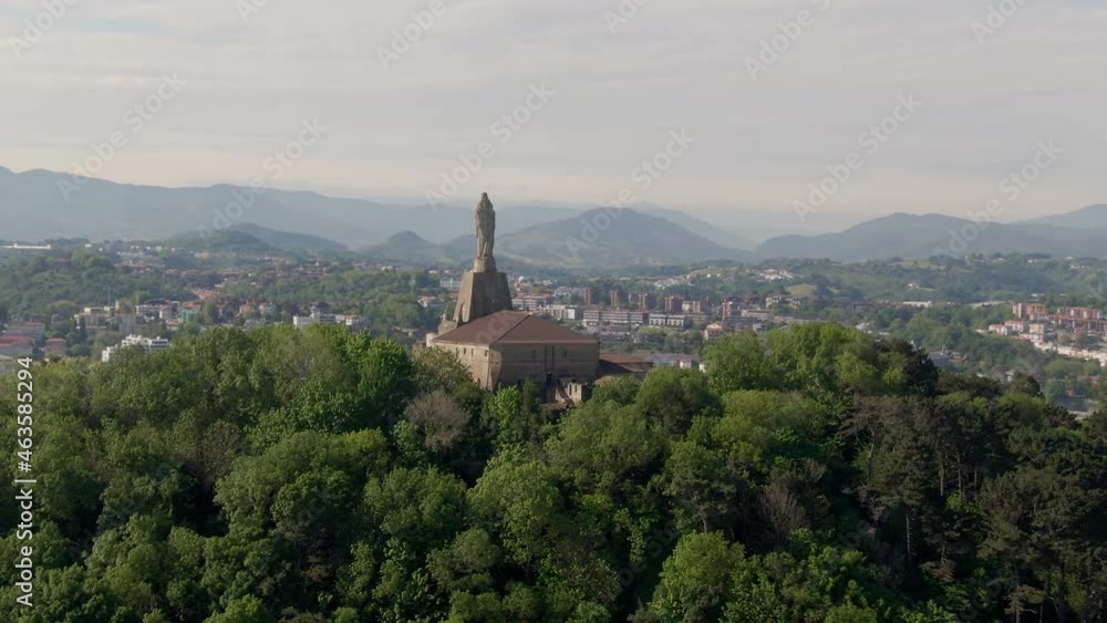 Statue monument and majestic view of San Sebastian and sandy beaches, ascending aerial view Statue monument and majestic view of San Sebastian and sandy beaches, ascending aerial view