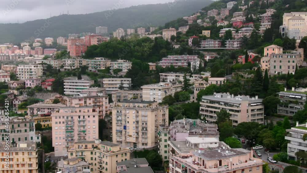 Cityscape of Genoa with forestry hilly landscape on foggy moody day, aerial view Cityscape of Genoa with forestry hilly landscape on foggy moody day, aerial view