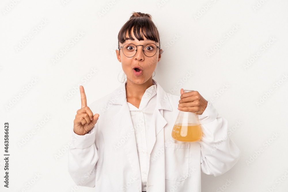 Young mixed race scientist woman holding a test tube isolated on white background having some great idea, concept of creativity. Young mixed race scientist woman holding a test tube isolated on white background having some great idea, concept of creativity.