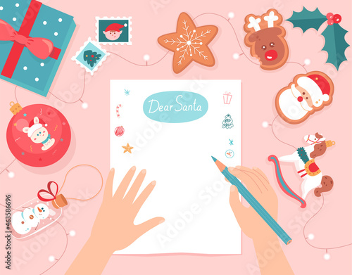 Hands writing Christmas letter to Santa Claus, person holding pencil to write wish list