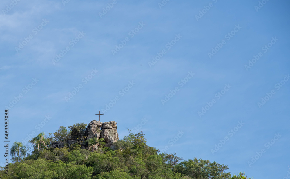 Religious monument on top of natural formation.