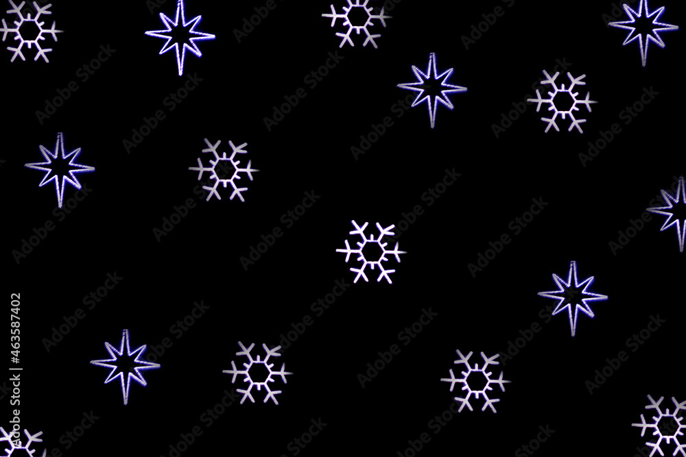 Christmas bokeh overlay background. Blue snowflakes light on the black background. New Year, festive atmosphere Christmas bokeh overlay background. Blue snowflakes light on the black background. New Year, festive atmosphere