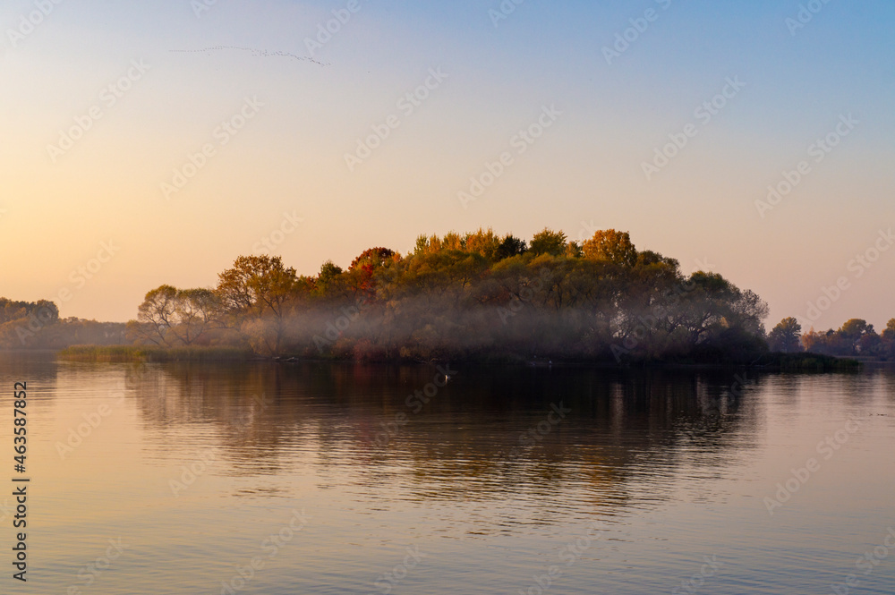 Beautiful island with fog at sunset. Summer landscape