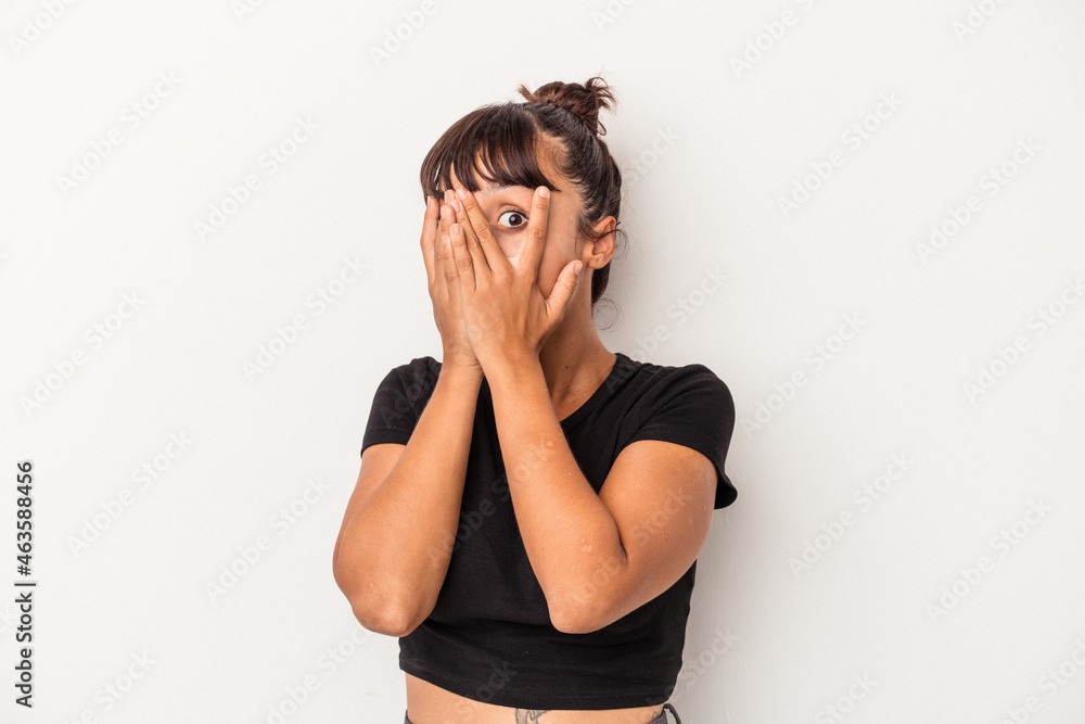 Young mixed race woman isolated on white background blink through fingers frightened and nervous. Young mixed race woman isolated on white background blink through fingers frightened and nervous.