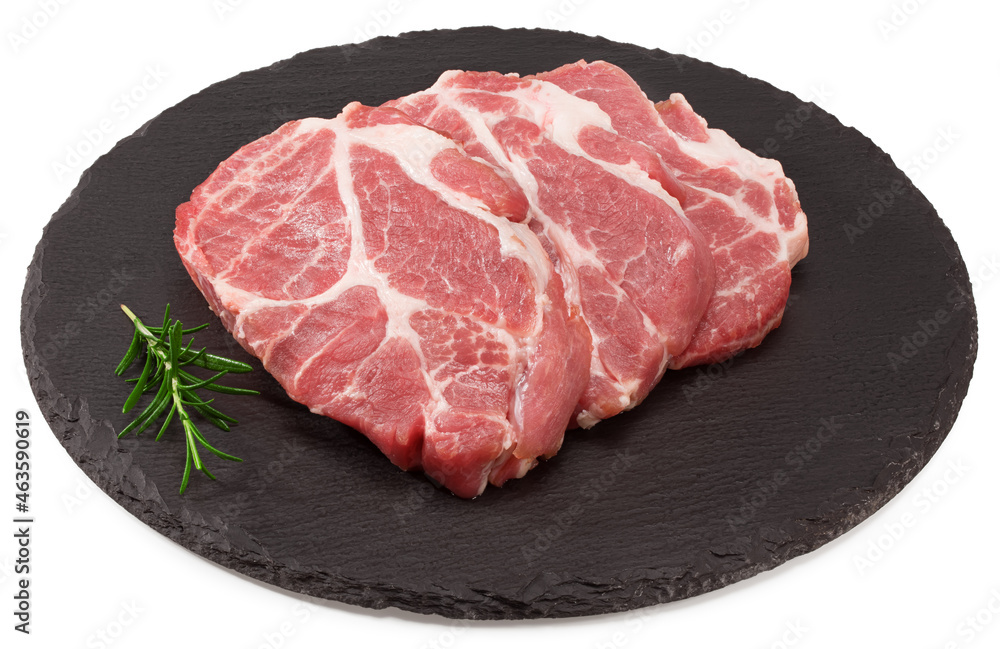 sliced raw pork meat with rosemar on black round stone plate isolated on white background. Clipping path and full depth of field sliced raw pork meat with rosemar on black round stone plate isolated on white background. Clipping path and full depth of field