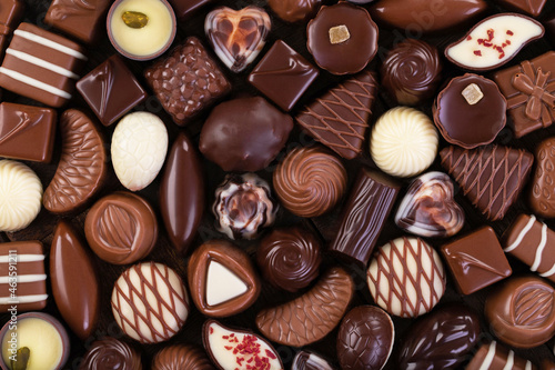 various chocolate candy and pralines, sweet food background