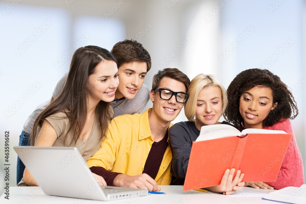 Diverse school kids using laptop computer together in classroom. Diverse school kids using laptop computer together in classroom.