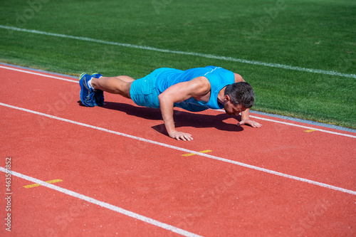 male athlete do morning exercise. pushups workout. sportsman planking outdoor.