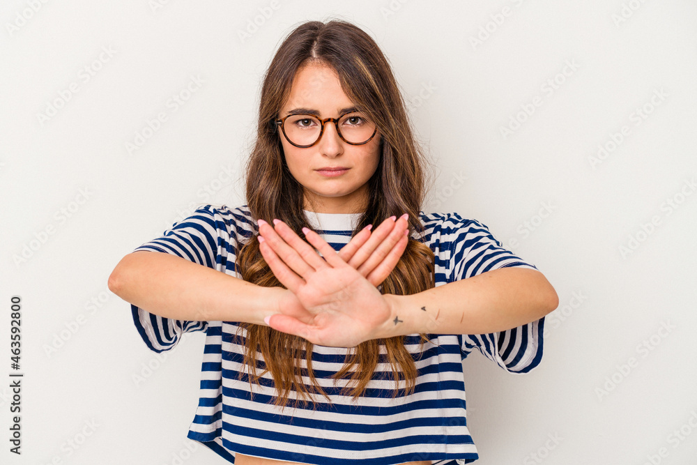 Young caucasian woman isolated on white background standing with outstretched hand showing stop sign, preventing you. Young caucasian woman isolated on white background standing with outstretched hand showing stop sign, preventing you.