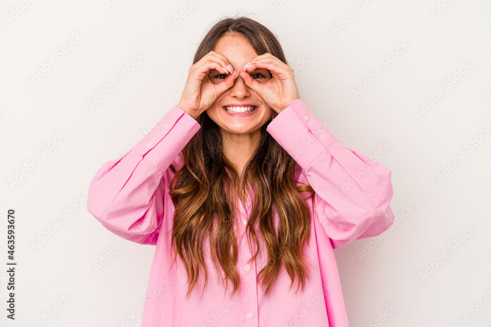 Young caucasian woman isolated on white background showing okay sign over eyes Young caucasian woman isolated on white background showing okay sign over eyes